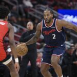 Houston, Texas, USA; Los Angeles Clippers forward Kawhi Leonard (2) dribbles the ball as Houston Rockets guard Amen Thompson (1) defends during the first quarter at Toyota Center. Mandatory Credit: Troy Taormina-Imagn Images