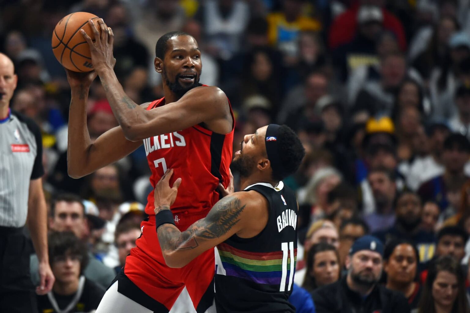 Denver, Colorado, USA; Houston Rockets forward Kevin Durant (7) holds the ball as he is defended by Denver Nuggets guard Bruce Brown (11) during the second half at Ball Arena. Mandatory Credit: Christopher Hanewinckel-Imagn Images