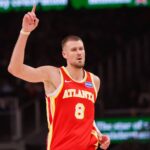 Atlanta, Georgia, USA; Atlanta Hawks center Kristaps Porzingis (8) reacts after a basket against the Toronto Raptors in the second quarter at State Farm Arena. Mandatory Credit: Brett Davis-Imagn Images