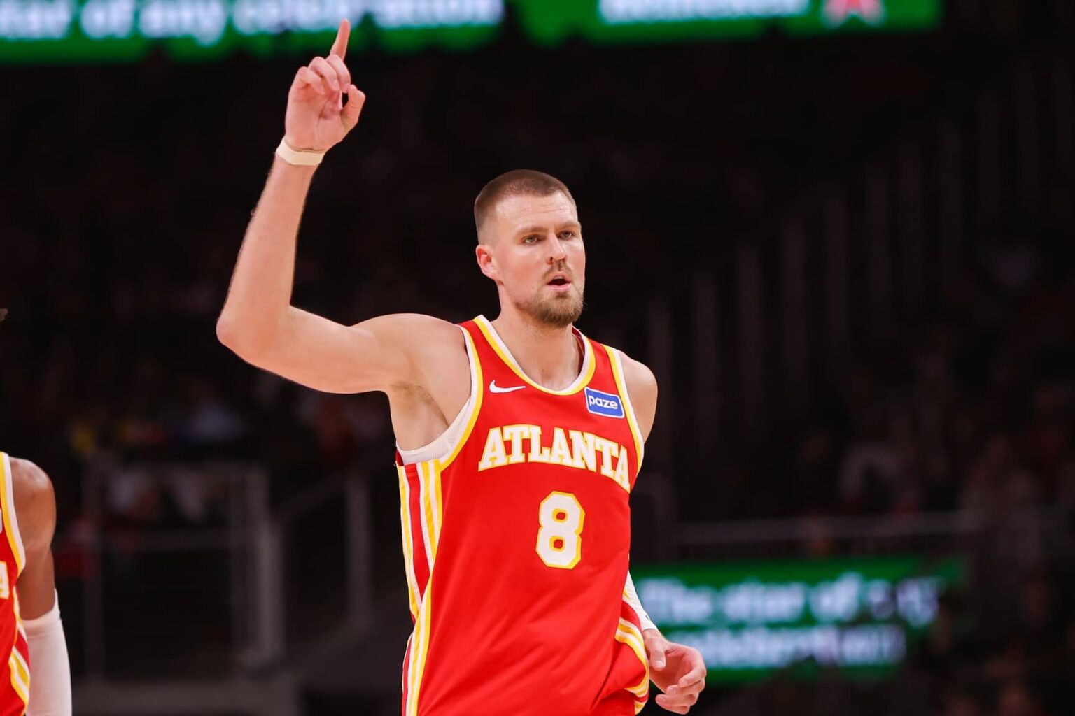 Atlanta, Georgia, USA; Atlanta Hawks center Kristaps Porzingis (8) reacts after a basket against the Toronto Raptors in the second quarter at State Farm Arena. Mandatory Credit: Brett Davis-Imagn Images