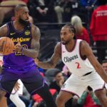Inglewood, California, USA; Los Angeles Lakers forward LeBron James (23) moves the ball against Los Angeles Clippers forward Kawhi Leonard (2) during the first half at Intuit Dome. Mandatory Credit: Gary A. Vasquez-Imagn Images