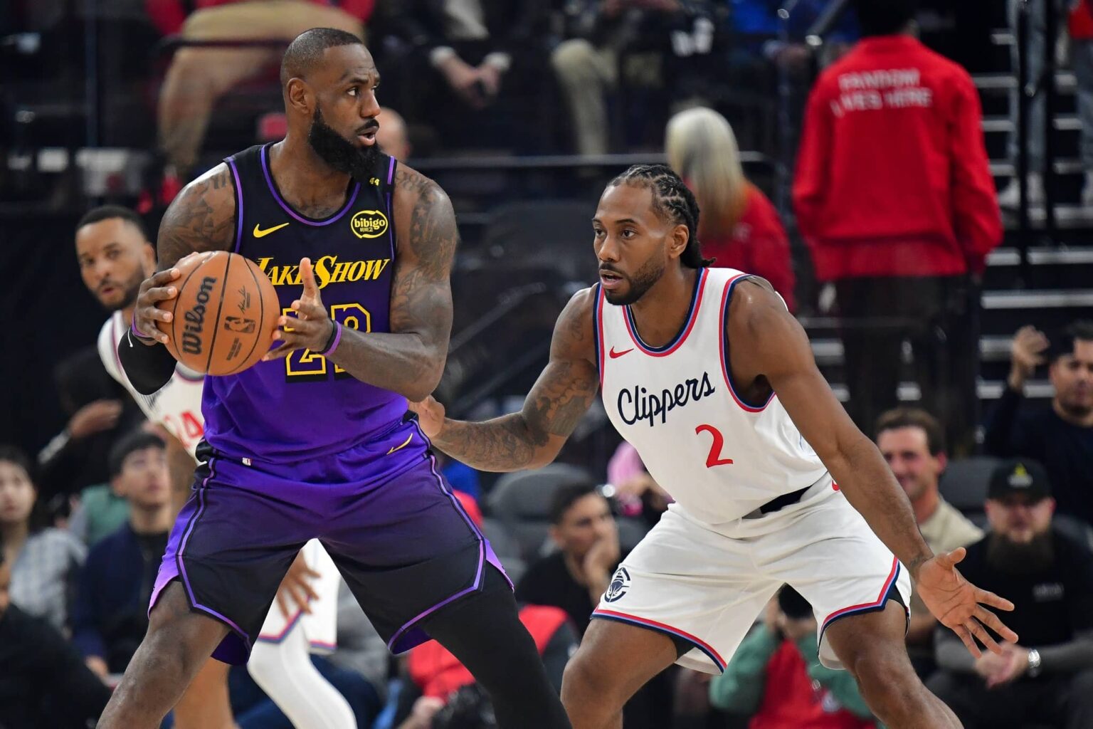 Inglewood, California, USA; Los Angeles Lakers forward LeBron James (23) moves the ball against Los Angeles Clippers forward Kawhi Leonard (2) during the first half at Intuit Dome. Mandatory Credit: Gary A. Vasquez-Imagn Images