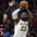 Philadelphia, Pennsylvania, USA; Los Angeles Lakers forward Lebron James (23) shoots past Philadelphia 76ers forward Dominick Barlow (25) during the first quarter at Xfinity Mobile Arena. Mandatory Credit: Bill Streicher-Imagn Images