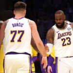 Los Angeles, California, USA; Los Angeles Lakers forward LeBron James (23) and guard Luka Doncic (77) react after a play during the first quarter against the LA Clippers at Crypto.com Arena. Mandatory Credit: Jason Parkhurst-Imagn Images