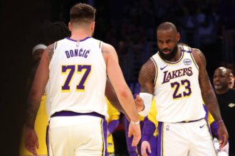 Los Angeles, California, USA; Los Angeles Lakers forward LeBron James (23) and guard Luka Doncic (77) react after a play during the first quarter against the LA Clippers at Crypto.com Arena. Mandatory Credit: Jason Parkhurst-Imagn Images