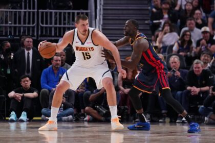 San Francisco, California, USA; Denver Nuggets center Nikola Jokic (15) is guarded by Golden State Warriors forward Draymond Green (23) in the third period at Chase Center. Mandatory Credit: David Gonzales-Imagn Images