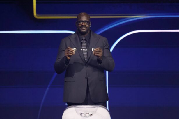Washington, District of Columbia, USA; Shaquille O'Neal draws the card of Iran for Group G during the FIFA World Cup 2026 Final Draw at John F. Kennedy Center for the Performing Arts. Mandatory Credit: Amber Searls-Imagn Images