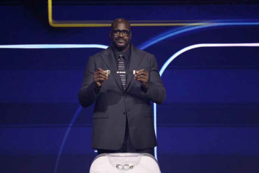Washington, District of Columbia, USA; Shaquille O'Neal draws the card of Iran for Group G during the FIFA World Cup 2026 Final Draw at John F. Kennedy Center for the Performing Arts. Mandatory Credit: Amber Searls-Imagn Images