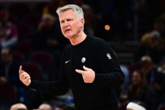 Cleveland, Ohio, USA; Golden State Warriors head coach Steve Kerr reacts against the Cleveland Cavaliers during the second half at Rocket Arena. Mandatory Credit: Ken Blaze-Imagn Images