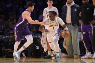 Sacramento Kings forward Doug McDermott (7) guards Los Angeles Lakers forward Adou Thiero (1) in the second half at Crypto.com Arena.
