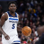 Dec 25, 2025; Denver, Colorado, USA; Minnesota Timberwolves guard Anthony Edwards (5) dribbles the ball against the Denver Nuggets during the first half at Ball Arena. Mandatory Credit: Ron Chenoy-Imagn Images