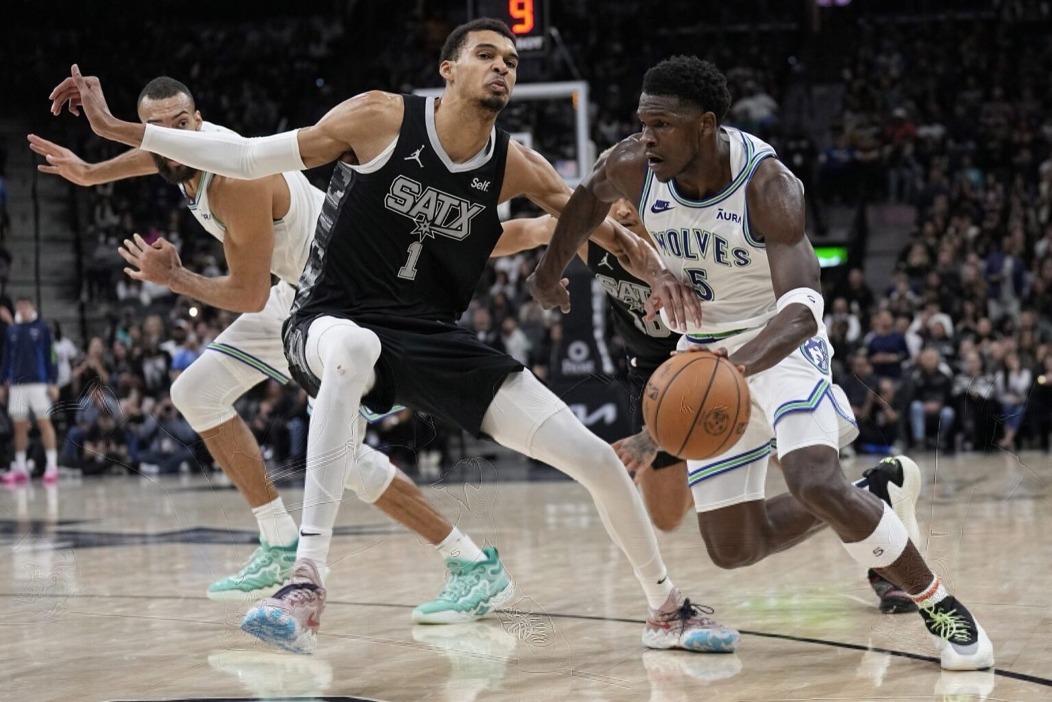 Jan 27, 2024; San Antonio, Texas, USA; Minnesota Timberwolves guard Anthony Edwards (5) drives to the basket against San Antonio Spurs forward Victor Wembanyama (1) during the second half at Frost Bank Center. Mandatory Credit: Scott Wachter-Imagn Images