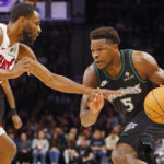 Jan 6, 2026; Minneapolis, Minnesota, USA; Minnesota Timberwolves guard Anthony Edwards (5) works around Miami Heat forward Andrew Wiggins (22) in the first quarter at Target Center. Mandatory Credit: Bruce Kluckhohn-Imagn Images