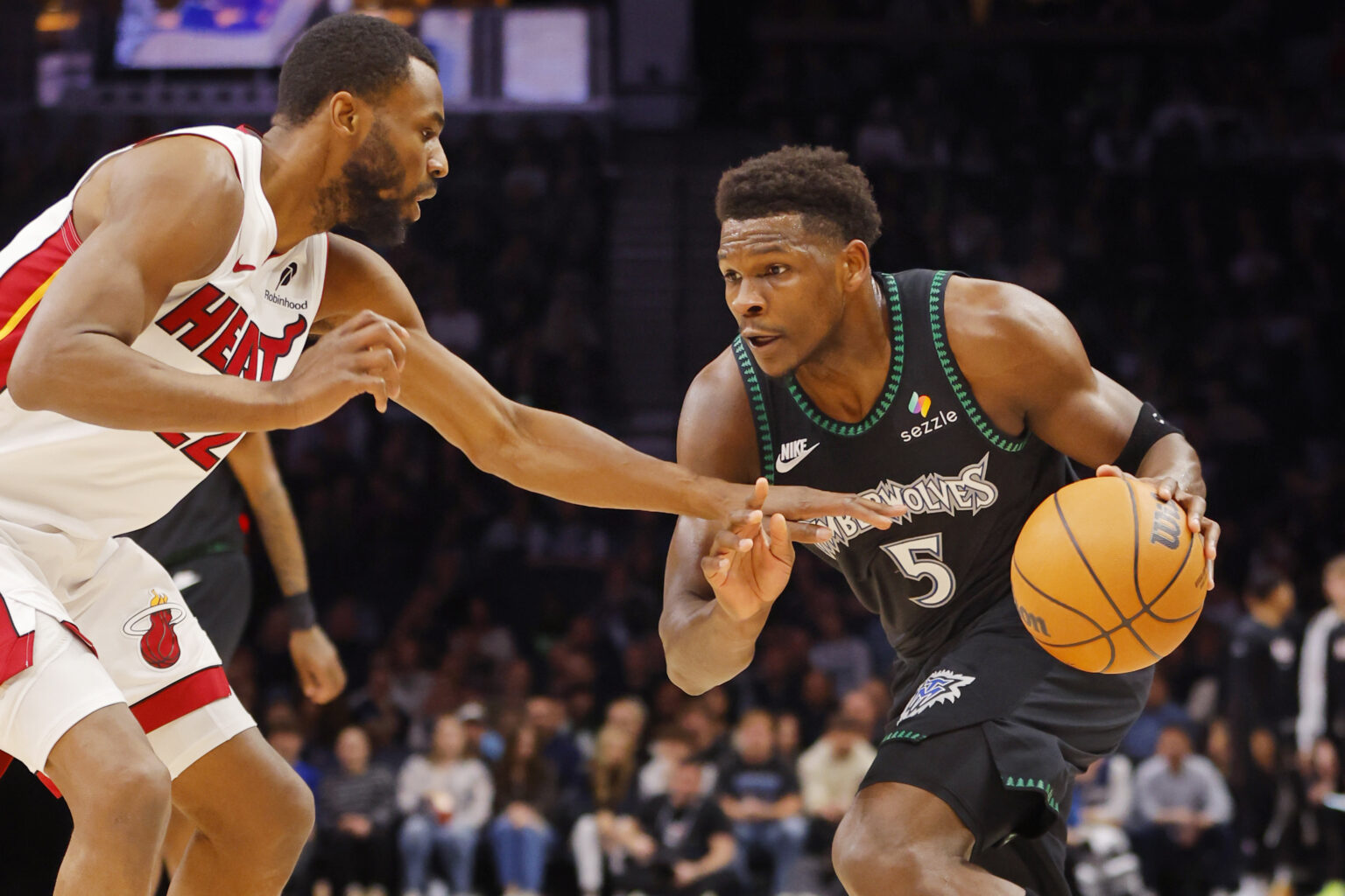 Jan 6, 2026; Minneapolis, Minnesota, USA; Minnesota Timberwolves guard Anthony Edwards (5) works around Miami Heat forward Andrew Wiggins (22) in the first quarter at Target Center. Mandatory Credit: Bruce Kluckhohn-Imagn Images