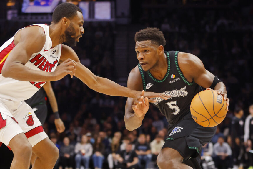 Jan 6, 2026; Minneapolis, Minnesota, USA; Minnesota Timberwolves guard Anthony Edwards (5) works around Miami Heat forward Andrew Wiggins (22) in the first quarter at Target Center. Mandatory Credit: Bruce Kluckhohn-Imagn Images