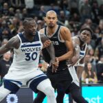 Minnesota Timberwolves forward Julius Randle (30) and guard Anthony Edwards (5) try to keep San Antonio Spurs forward Victor Wembanyama (1) from a rebound in the second half at Frost Bank Center.