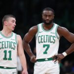 Dec 7, 2024; Boston, Massachusetts, USA; Boston Celtics forward Jaylen Brown (7) and Boston Celtics guard Payton Pritchard (11) talk during the first half against the Memphis Grizzlies at TD Garden. Mandatory Credit: Paul Rutherford-Imagn Images