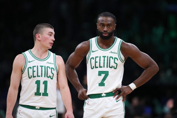 Dec 7, 2024; Boston, Massachusetts, USA; Boston Celtics forward Jaylen Brown (7) and Boston Celtics guard Payton Pritchard (11) talk during the first half against the Memphis Grizzlies at TD Garden. Mandatory Credit: Paul Rutherford-Imagn Images