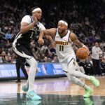 Jan 23, 2026; Milwaukee, Wisconsin, USA; Denver Nuggets guard Bruce Brown (11) drives towards the basket against Milwaukee Bucks center Myles Turner (3) during the fourth quarter at Fiserv Forum. Mandatory Credit: Jeff Hanisch-Imagn Images