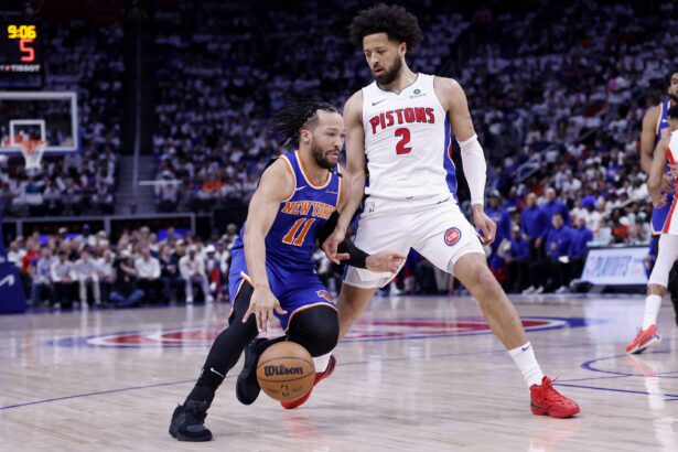 New York Knicks guard Jalen Brunson (11) dribbles defended by Detroit Pistons guard Cade Cunningham (2) in the first half during game six of first round for the 2024 NBA Playoffs at Little Caesars Arena.