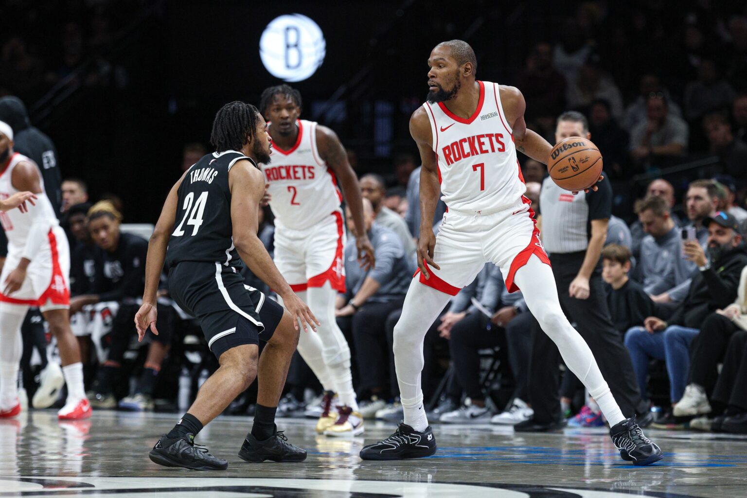 Jan 1, 2026; Brooklyn, New York, USA; Houston Rockets forward Kevin Durant (7) is guarded by Brooklyn Nets guard Cam Thomas (24) during the first half at Barclays Center. Mandatory Credit: Vincent Carchietta-Imagn Images