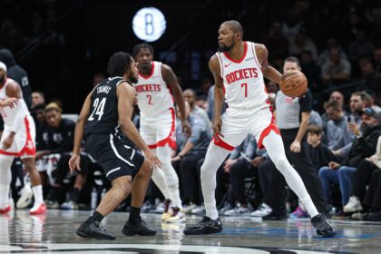 Jan 1, 2026; Brooklyn, New York, USA; Houston Rockets forward Kevin Durant (7) is guarded by Brooklyn Nets guard Cam Thomas (24) during the first half at Barclays Center. Mandatory Credit: Vincent Carchietta-Imagn Images