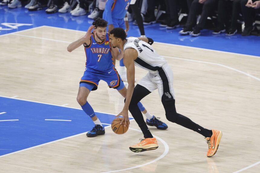 Jan 13, 2026; Oklahoma City, Oklahoma, USA; San Antonio Spurs forward/center Victor Wembanyama (1) drives to the basket past Oklahoma City Thunder center/forward Chet Holmgren (7) during the first quarter at Paycom Center. Mandatory Credit: Alonzo Adams-Imagn Images