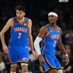 Jan 4, 2026; Phoenix, Arizona, USA; Oklahoma City Thunder guard Shai Gilgeous-Alexander (2) and center Chet Holmgren (7) against the Phoenix Suns at Mortgage Matchup Center. Mandatory Credit: Mark J. Rebilas-Imagn Images