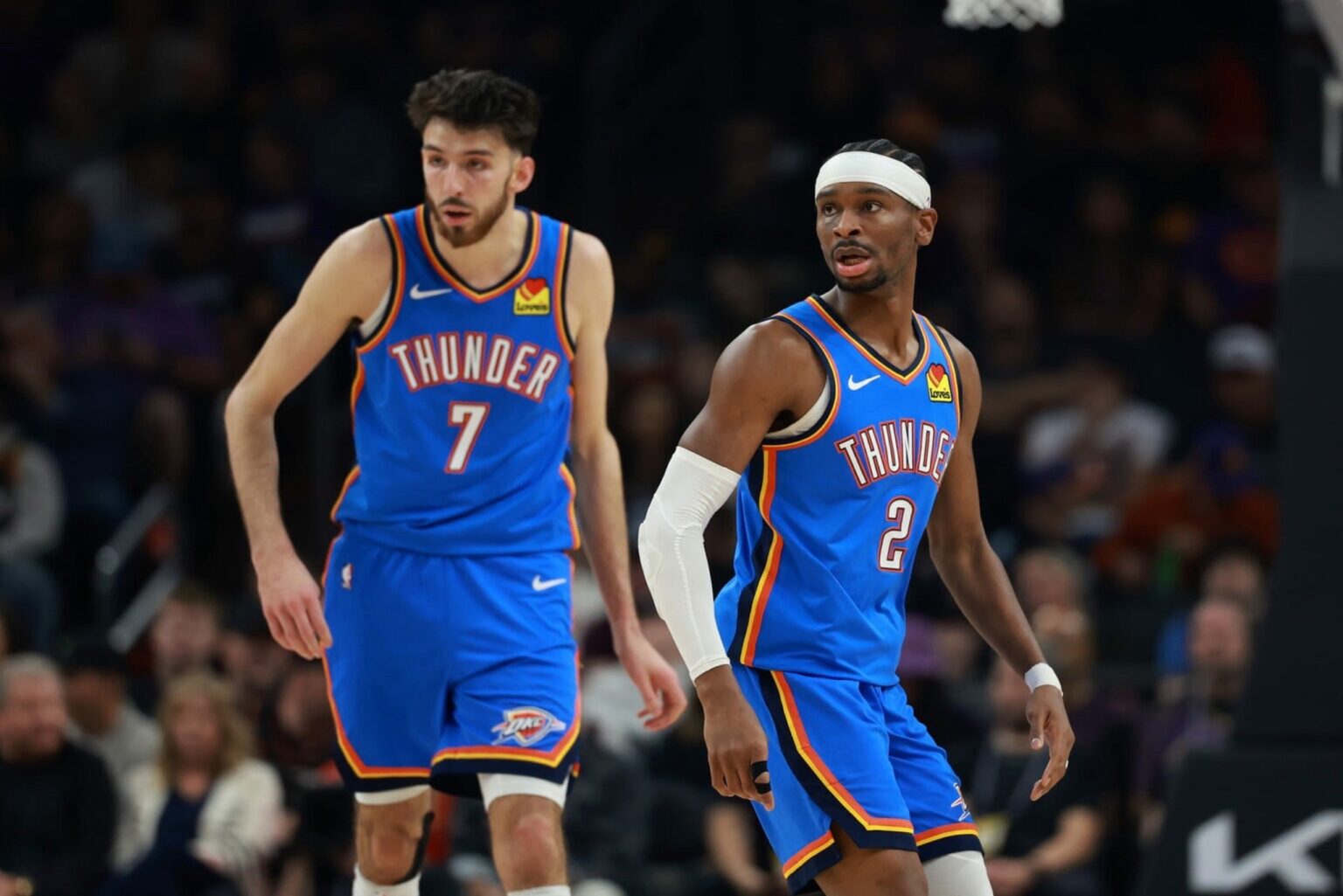 Jan 4, 2026; Phoenix, Arizona, USA; Oklahoma City Thunder guard Shai Gilgeous-Alexander (2) and center Chet Holmgren (7) against the Phoenix Suns at Mortgage Matchup Center. Mandatory Credit: Mark J. Rebilas-Imagn Images