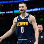 Jan 7, 2026; Boston, Massachusetts, USA; Denver Nuggets guard Christian Braun (0) reacts after a play during the second half against the Boston Celtics at TD Garden. Mandatory Credit: Bob DeChiara-Imagn Images