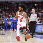 Jan 10, 2026; Chicago, Illinois, USA; Chicago Bulls guard Coby White (0) brings the ball up court against the Dallas Mavericks during the first half at United Center. Mandatory Credit: Kamil Krzaczynski-Imagn Images
