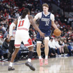 Jan 10, 2026; Chicago, Illinois, USA; Dallas Mavericks forward Cooper Flagg (32) brings the ball up court against Chicago Bulls guard Ayo Dosunmu (11) during the second half at United Center. Mandatory Credit: Kamil Krzaczynski-Imagn Images