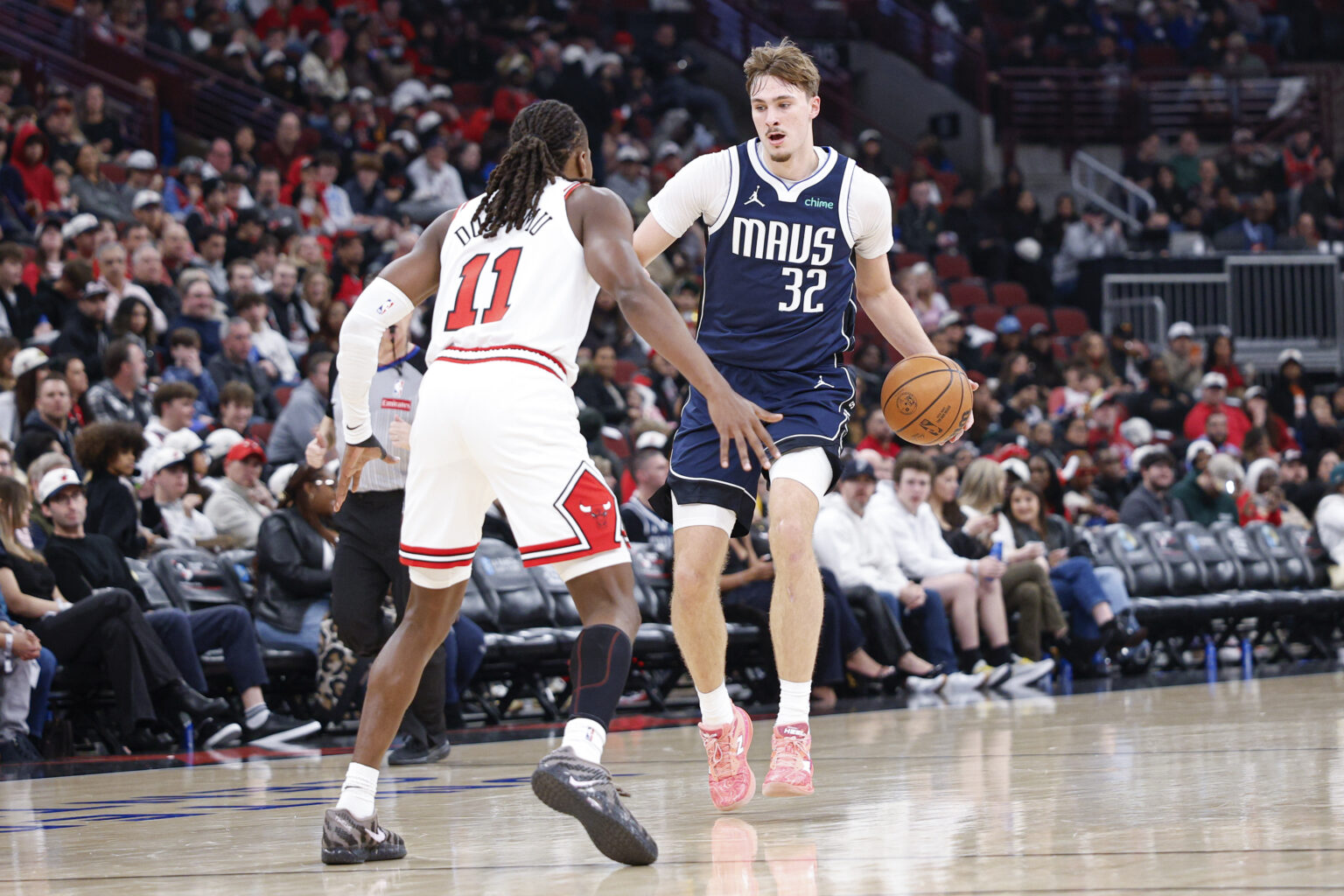 Jan 10, 2026; Chicago, Illinois, USA; Dallas Mavericks forward Cooper Flagg (32) brings the ball up court against Chicago Bulls guard Ayo Dosunmu (11) during the second half at United Center. Mandatory Credit: Kamil Krzaczynski-Imagn Images