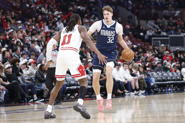 Jan 10, 2026; Chicago, Illinois, USA; Dallas Mavericks forward Cooper Flagg (32) brings the ball up court against Chicago Bulls guard Ayo Dosunmu (11) during the second half at United Center. Mandatory Credit: Kamil Krzaczynski-Imagn Images