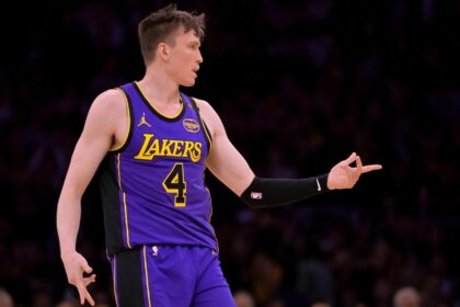Apr 4, 2025; Los Angeles, California, USA; Los Angeles Lakers guard Dalton Knecht (4) reacts after a 3-point basket in the first half against the New Orleans Pelicans at Crypto.com Arena. Mandatory Credit: Jayne Kamin-Oncea-Imagn Images