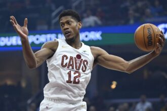 Dec 3, 2025; Cleveland, Ohio, USA; Cleveland Cavaliers forward De'Andre Hunter (12) rebounds in the first quarter against the Portland Trail Blazers at Rocket Arena. Mandatory Credit: David Richard-Imagn Images