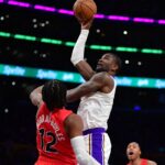 Jan 18, 2026; Los Angeles, California, USA; Los Angeles Lakers center Deandre Ayton (5) shoots against Toronto Raptors forward Collin Murray-Boyles (12) during the first half at Crypto.com Arena. Mandatory Credit: Gary A. Vasquez-Imagn Images