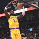 Dec 4, 2025; Toronto, Ontario, CAN; Los Angeles Lakers center Deandre Ayton (5) dunks for a basket over Toronto Raptors guard Immanuel Quickley (5) in the first half at Scotiabank Arena. Mandatory Credit: Dan Hamilton-Imagn Images