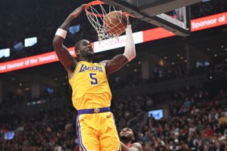 Dec 4, 2025; Toronto, Ontario, CAN; Los Angeles Lakers center Deandre Ayton (5) dunks for a basket over Toronto Raptors guard Immanuel Quickley (5) in the first half at Scotiabank Arena. Mandatory Credit: Dan Hamilton-Imagn Images