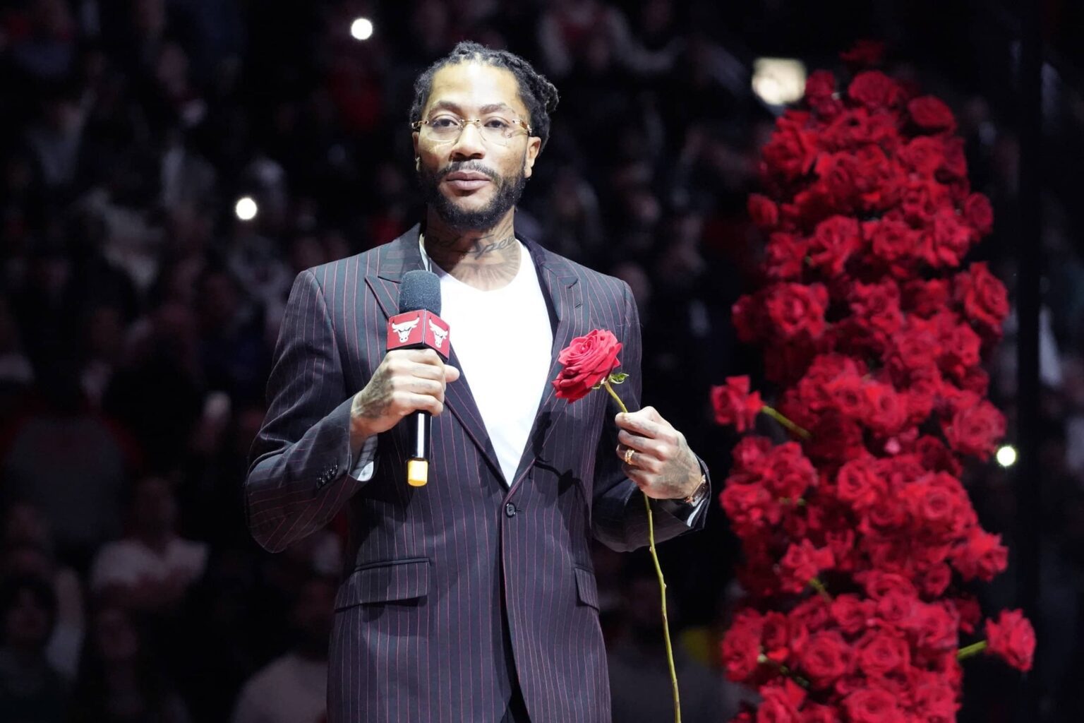 Chicago Bulls and New York Knicks former player Derrick Rose speaks as he is honored at halftime of a game between the Chicago Bulls and the New York Knicks at United Center.