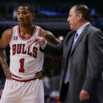 Chicago Bulls point guard Derrick Rose (1) talks with head coach Tom Thibodeau during the first quarter of a preseason game against the Toronto Raptors at the United Center.