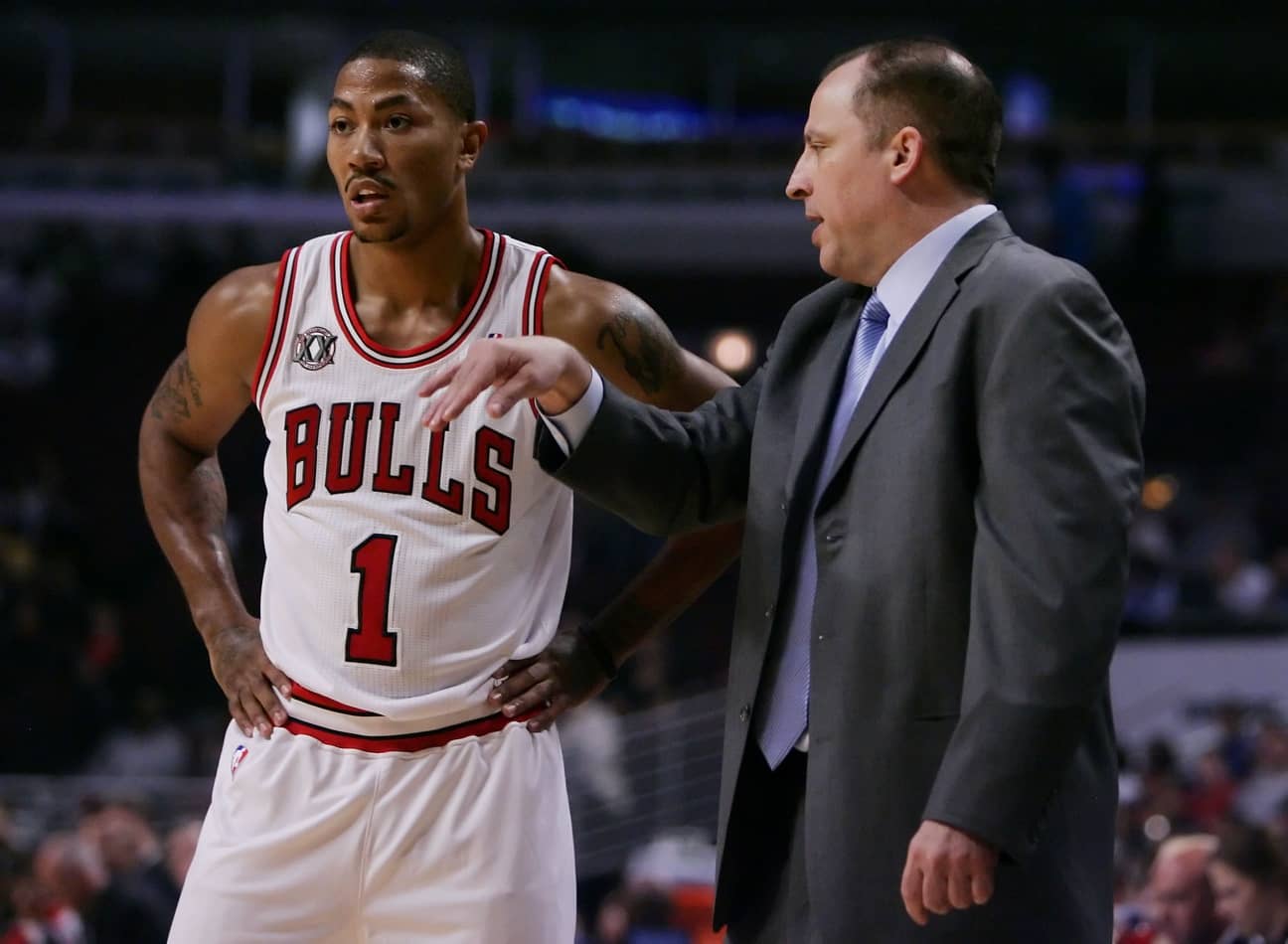 Chicago Bulls point guard Derrick Rose (1) talks with head coach Tom Thibodeau during the first quarter of a preseason game against the Toronto Raptors at the United Center.