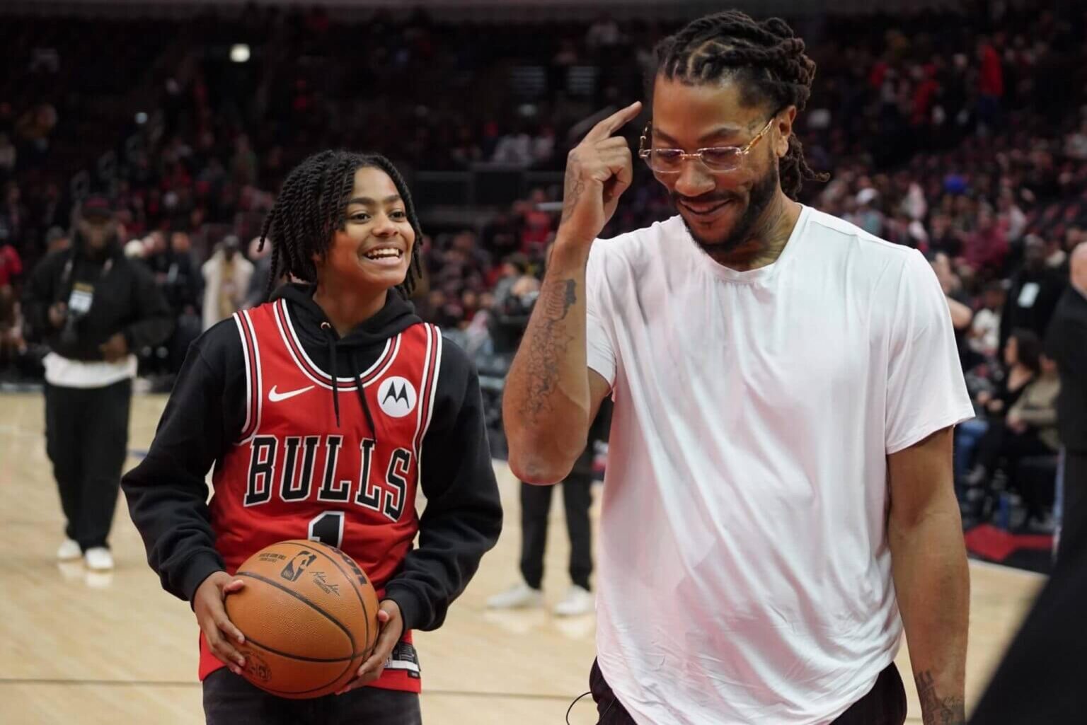 Jan 4, 2025; Chicago, Illinois, USA; Chicago Bulls and New York Knicks former player Derrick Rose shoots baskets with his son PJ. Rose before a game between the Chicago Bulls and the New York Knicks at United Center. Rose will be honored at halftime of the game. Mandatory Credit: David Banks-Imagn Images