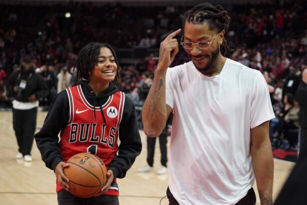 Jan 4, 2025; Chicago, Illinois, USA; Chicago Bulls and New York Knicks former player Derrick Rose shoots baskets with his son PJ. Rose before a game between the Chicago Bulls and the New York Knicks at United Center. Rose will be honored at halftime of the game. Mandatory Credit: David Banks-Imagn Images