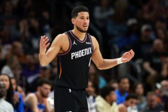 Jan 4, 2026; Phoenix, Arizona, USA; Phoenix Suns guard Devin Booker (1) reacts against the Oklahoma City Thunder in the first half at Mortgage Matchup Center. Mandatory Credit: Mark J. Rebilas-Imagn Images