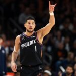 Jan 11, 2026; Phoenix, Arizona, USA; Phoenix Suns guard Devin Booker (1) reacts against the Washington Wizards in the first half at Mortgage Matchup Center. Mandatory Credit: Mark J. Rebilas-Imagn Images