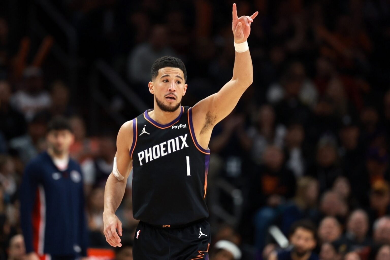 Jan 11, 2026; Phoenix, Arizona, USA; Phoenix Suns guard Devin Booker (1) reacts against the Washington Wizards in the first half at Mortgage Matchup Center. Mandatory Credit: Mark J. Rebilas-Imagn Images