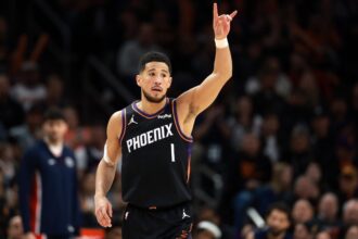 Jan 11, 2026; Phoenix, Arizona, USA; Phoenix Suns guard Devin Booker (1) reacts against the Washington Wizards in the first half at Mortgage Matchup Center. Mandatory Credit: Mark J. Rebilas-Imagn Images