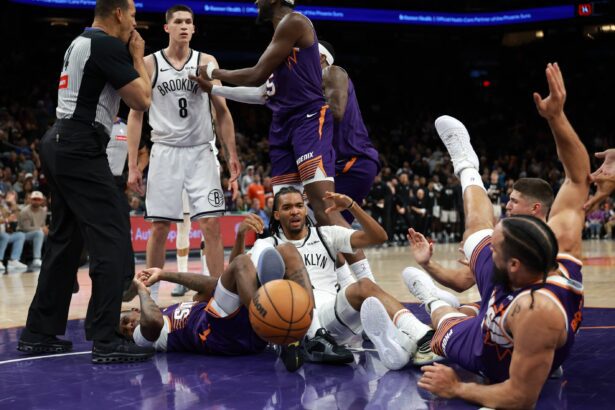 Jan 27, 2026; Phoenix, Arizona, USA; Brooklyn Nets guard Egor Demin (8) reacts after pushing Phoenix Suns forward Dillon Brooks to the ground to start a fight in the second half at Mortgage Matchup Center. Mandatory Credit: Mark J. Rebilas-Imagn Images