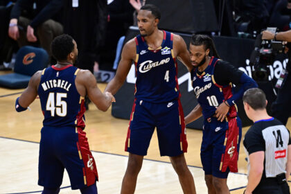 Jan 2, 2026; Cleveland, Ohio, USA; Cleveland Cavaliers center Evan Mobley (4) congratulates guard Donovan Mitchell (45) and guard Darius Garland (10) after the Cavaliers defeated the Denver Nuggets at Rocket Arena. Mandatory Credit: David Dermer-Imagn Images